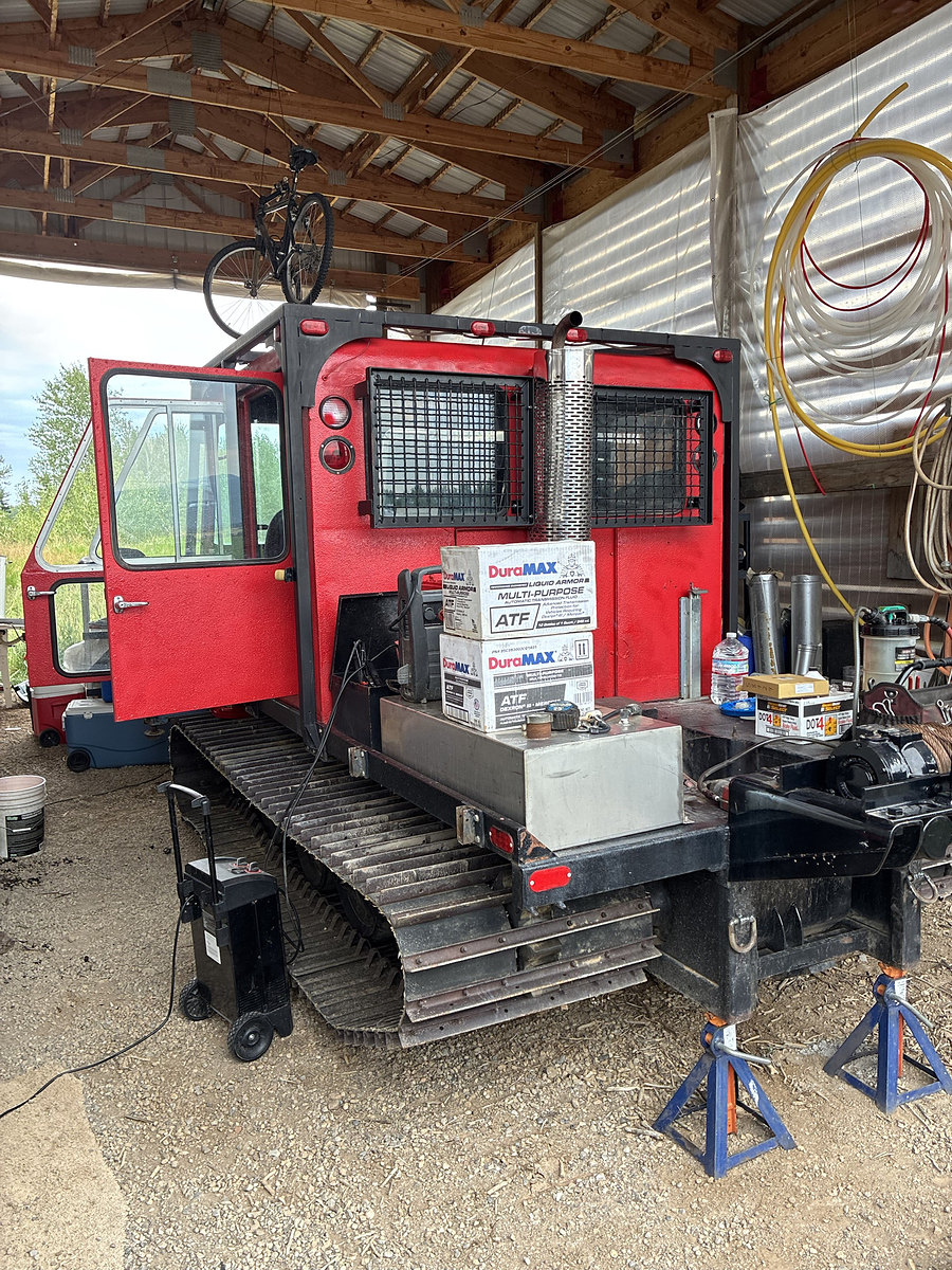Red snowcat being serviced