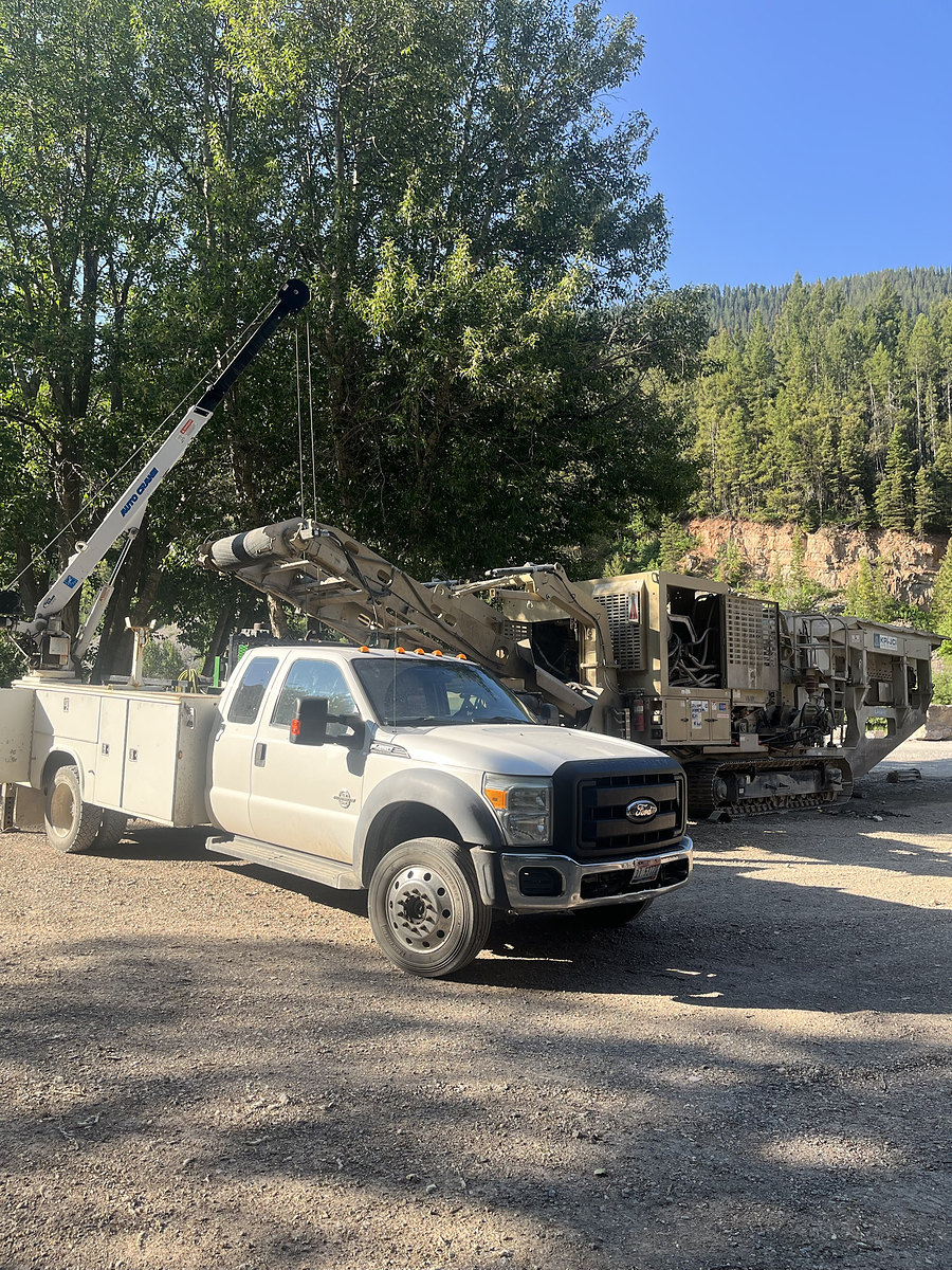 Service truck beside a rock crusher